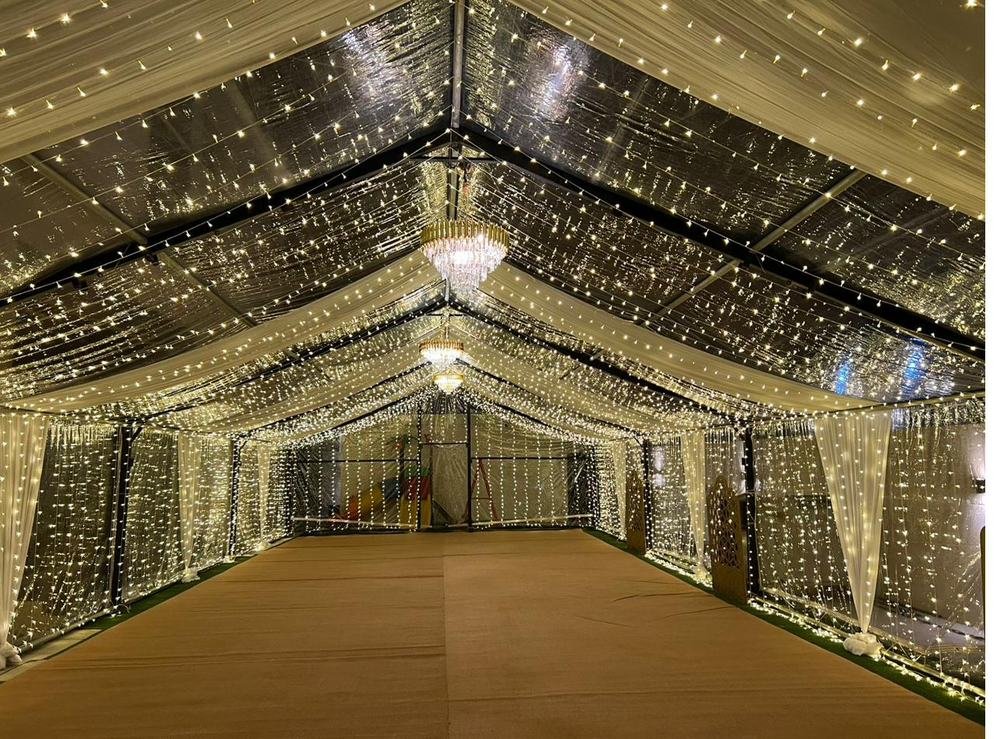 Marquee tent interior with chandeliers and fairy lights