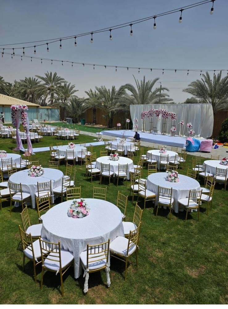Outdoor garden wedding with floral stage backdrop