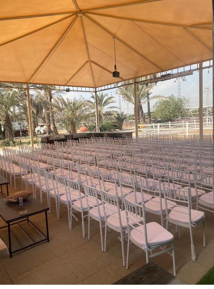 Large canopy seating area with palm trees