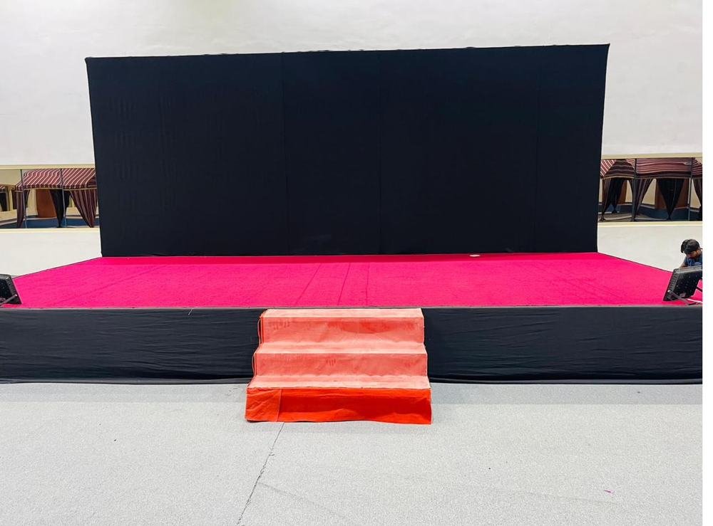 Event stage with pink carpet and black backdrop